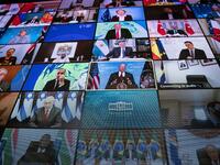 World leaders are seen remotely on a screen as U.S. President Joe Biden delivers remarks during a virtual Leaders Summit on Climate with 40 world leaders in the East Room of the White House 