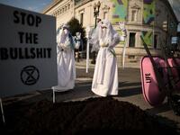 WASHINGTON, DC - APRIL 22: Activists halt traffic and dump a pile of manure outside the White House while protesting against President Joe Biden's climate change policy on Earth Day
