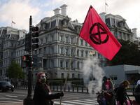WASHINGTON, DC - APRIL 22: Activists halt traffic outside the White House while protesting against President Joe Biden's climate change policy on Earth Day, April 22, 2021 in Washington, DC. Organized by the Extinction Rebellion DC, protesters used bright pink wheelbarrows to dump heaps of cow manure at the intersection of New York Avenue and 17th Street NW on the west side of the White House campus. Despite the White House hosting a virtual Leaders Summit on Climate on Earth Day