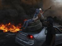 Palestinians burn tires during a night demonstration against the expansion of the Jewish settlement outpost of Eviatar on the lands of Beita village, near the occupied West Bank city of Nablus