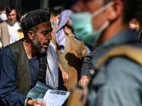 A man arrives to submit his passport application at an office in Kabul on July 25, 2021. Dozens begin lining up at the passport office in Kabul before dawn most days, and by eight in the morning the queue already stretches for a good hundred metres.