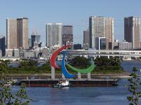 The Paralympic Symbol "the three agitos", 23.4m wide and 17.5m high, is brought by a salvage barge to install at the Tokyo waterfront in the waters of Odaiba Marine Park on August 20, 2021, four days before the opening of the Tokyo 2020 Paralympic Games. 