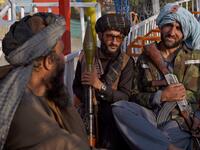 "This is Afghanistan!" a Taliban fighter shouts on the pirate ship ride at a fairground in western Kabul, as his armed comrades cackle and whoop on board the rickety attraction. (Photo by WAKIL KOHSAR / AFP) / TO GO WITH: AFGHANISTAN-CONFLICT-FAIRGROUND, SCENE BY JAMES EDGAR - TO GO WITH: Afghanistan-conflict-fairground, SCENE by James EDGAR