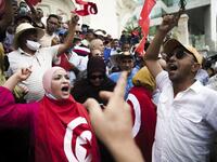 Protesters angry at the Tunisian president’s seizure of broad powers faced off with his supporters Saturday in competing demonstrations in the North African nation's capital of Tunis.