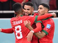 Morocco's forward #19 Youssef En-Nesyri (C) celebrates with Morocco's midfielder #08 Azzedine Ounahi (L) and Morocco's defender #02 Achraf Hakimi after he scored his team's first goal during the Qatar 2022 World Cup quarter-final football match between Morocco and Portugal at the Al-Thumama Stadium in Doha on December 10, 2022. (Photo by Kirill KUDRYAVTSEV / AFP)