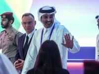 Qatar's Emir, Sheikh Tamim bin Hamad Al-Thani (R) waves as he walks alongside Poland's President Andrzej Duda (C) at the Qatar Economic Forum in Doha on May 14, 2024. (Photo by KARIM JAAFAR / AFP)
