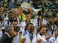 Real Madrid's French forward #09 Kylian Mbappe celebrates with the trophy after the UEFA Super Cup football match between Real Madrid and Atalanta BC in Warsaw, on August 14, 2024. (Photo by Sergei GAPON / AFP)