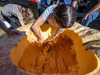 Teams carve a giant pumpkin to create a pirate boat during the Giant Pumpkin Weigh-off and Regatta in Goffstown, New Hampshire on October 19, 2024. (Photo by Joseph Prezioso / AFP)
