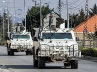 United Nations peacekeepers ride in vehicles