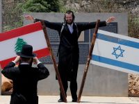 Jew standing on monument on the Lebanese-Israeli border