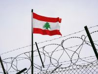 Lebanese flag behind barbed wire