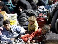 Syrian civilians, evacuated from rebel-held areas in the Eastern Ghouta, gather at a school in the regime-controlled Adra district, on the northeastern outskirts of the capital Damascus on Mar. 16, 2018. .
(LOUAI BESHARA / AFP)