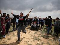 A picture taken on Mar. 30, 2018 shows a Palestinian youth being carried on an all-terrain vehicle after being injured during a demonstration near the border with Israel east of Jabalia in the Gaza strip commemorating Land Day. (MOHAMMED ABED / AFP)