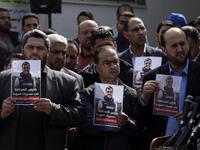 Palestinian journalists carry a portrait of journalist Yasser Murtaja, during his funeral in Gaza City on Apr. 7, 2018. (MAHMUD HAMS / AFP)