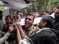 Mourners carry the body of 29-year-old Saadi Abu Taha who was killed during clashes along the Israel-Gaza border, as they walk in a funerary procession in Khan Yunis in the southern Gaza strip on Apr. 21, 2018. 
(SAID KHATIB / AFP)