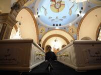 A Coptic priest blesses the coffins of victims, killed in an attack a day earlier, during an early morning ceremony at the Prince Tadros church in Egypt's southern Minya province, on November 3, 2018. 
MOHAMED EL-SHAHED / AFP