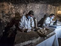 Egyptian archaeologists work on monuments after being discovered on the stony edge of King Userkaf pyramid complex in Saqqara Necropolis, south of the capital Cairo. (KHALED DESOUKI / AFP)