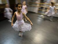 Girls attend a class at a ballet studio in Moscow on November 22, 2018. In a small studio in northern Moscow, parents and grandparents sit in a corridor waiting for children as young as three to finish their ballet class. 
Mladen ANTONOV / AFP