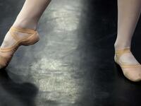 A girl attends a class at a ballet studio in Moscow on November 22, 2018. In a small studio in northern Moscow, parents and grandparents sit in a corridor waiting for children as young as three to finish their ballet class. 
Mladen ANTONOV / AFP