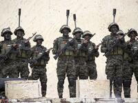 Palestinian members of al-Qassam Brigades, the armed wing of the Hamas movement, attend a rally marking the 31st anniversary of Hamas' founding, in Gaza City December 16, 2018. 
SAID KHATIB / AFP