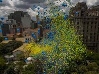 Thousands of biodegradable balloons are released by members of the Chamber of Commerce to celebrate New Year in Sao Paulo, Brazil, on December 28, 2017. 
Miguel SCHINCARIOL / AFP