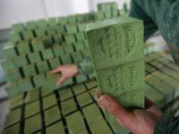Syrian workers arrange olive soap bars in a factory on the outskirts of Aleppo 
LOUAI BESHARA / AFP