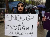 A Lebanese woman hold a placard as she participates in a march against marriage before the age of 18, in the capital Beirut on March 2, 2019. The Arabic writing on the placard reads "Not before 18". 
ANWAR AMRO / AFP
