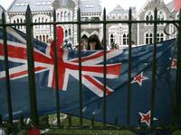A woman reacts as as she pays her respects in front of floral tributes for victims of the March 15 mosque attacks, in Christchurch 
DAVID MOIR / AFP