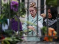 People pay their respects in front of floral tributes for victims of the March 15 mosque attacks, in Christchurch 
DAVID MOIR / AFP