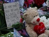 A note is seen beside floral tributes at a makeshift memorial for victims of the March 15 mosque attacks, in Christchurch 
DAVID MOIR / AFP