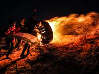 Palestinian protesters take part in a night demonstration near the fence along the border with Israel, in Rafah
SAID KHATIB / AFP
