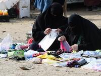 Displaced women sell clothing items in the souk or market of Al-Hol camp for displaced people in northeastern Syria
GIUSEPPE CACACE / AFP