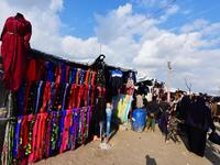 People walk past clothing stalls in the souk or market of Al-Hol camp for displaced people in northeastern Syria
GIUSEPPE CACACE / AFP