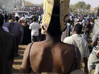 A Sudanese protester with a bare back walks with a sign behind reading in Arabic "Just fall that is all" during a demonstration in front of the military headquarters in the capital Khartoum on April 9, 2019.
AFP
