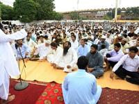 A congregation listens as Hafiz Mohammad Saeed (L), chief of Pakistan's outlawed Islamic hardline Jamaat ud Dawa (JD), delivers his sermon following congregational Eid al-Fitr prayers in Lahore on August 9, 2013. Saeed was the mastermind behind the 2008 terror attacks in Mumbai. (AFP)

