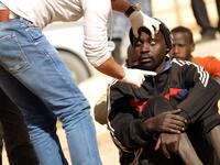 A sub-Saharan migrant undergoes a medical check-up before being repatriated from the Qanfouda detention center, in the southern outskirts of Benghazi, on Dec. 2, 2017. 
(Abdullah DOMA / AFP)