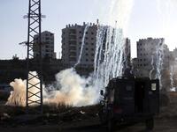 Israeli forces fire teargas at Palestinian demonstrators during clashes near an Israeli checkpoint in the West Bank city of Ramallah.
(ABBAS MOMANI / AFP)