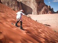 Girl sand boarding on dunes in Wadi Rum, Jordan (Shutterstock/File Photo)