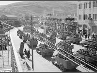 On the podium in the distant right of picture can be seen Emir Abdullah at a celebration in Amman, Jordan, of the 24th anniversary of Arab revolt - circa 1940. (flickriver.com) 