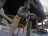 A man sits in a street near destroyed buildings in the Palestinian camp of Yarmuk southern Damascus on November 1, 2018. 
LOUAI BESHARA / AFP