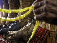 Members of an Iraqi clan gather inside a straw tent in the town of Mishkhab, south of Najaf on November 15, 2018. 
Haidar HAMDANI / AFP