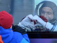 David Saint-Jacques of the Canadian Space Agency, a member of the International Space Station (ISS) expedition 58/59, gestures from inside a bus as he leaves to board the Soyuz MS-11 spacecraft shortly before the launch at the Russian-leased Baikonur cosmodrome in Kazakhstan on December 3, 2018. 
Kirill KUDRYAVTSEV / AFP