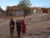 Women carry children as they walk in Sharboty Saghira, a small village east of regional capital Arbil.
SAFIN HAMED / AFP