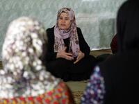 Rasul (C), an Iraqi Kurdish activist with the non-profit organisation WADI, speaks to women and young girls about the harms of genital mutilation in Sharboty Saghira.
SAFIN HAMED / AFP