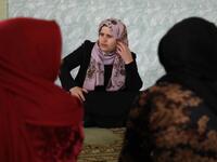Rasul (C), an Iraqi Kurdish activist with the non-profit organisation WADI, speaks to women and young girls about the harms of genital mutilation in Sharboty Saghira.
SAFIN HAMED / AFP
