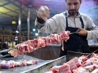Pakistani cook prepares meat to be grilled at the Charsi (Hashish) Tikka restaurant in Namak Mandi in Peshawar.
ABDUL MAJEED / AFP