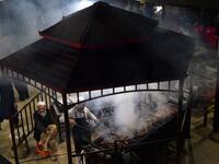 Pakistani man cooks grilled meat on a barbeque at the Charsi (Hashish) Tikka restaurant in Namak Mandi in Peshawar.
ABDUL MAJEED / AFP