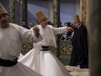People look at whirling dervishes performing during a ceremony marking the anniversary of the death of Jelaleddin Mevlana Rumi, Sufi mystic, poet and founder of the sufism on December 16, 2018 at Galata Mevlihanesi in Istanbul. 
Yasin AKGUL / AFP
