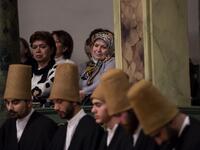 People look at whirling dervishes performing during a ceremony marking the anniversary of the death of Jelaleddin Mevlana Rumi, Sufi mystic, poet and founder of the sufism on December 16, 2018 at Galata Mevlihanesi in Istanbul. 
Yasin AKGUL / AFP