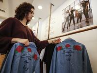 Palestinian fashion designer Yasmeen Mjalli  in her clothing shop where her label collection "BabyFist" carrying anti-sexual harassment slogans is showcased, in Ramallah 
ABBAS MOMANI / AFP